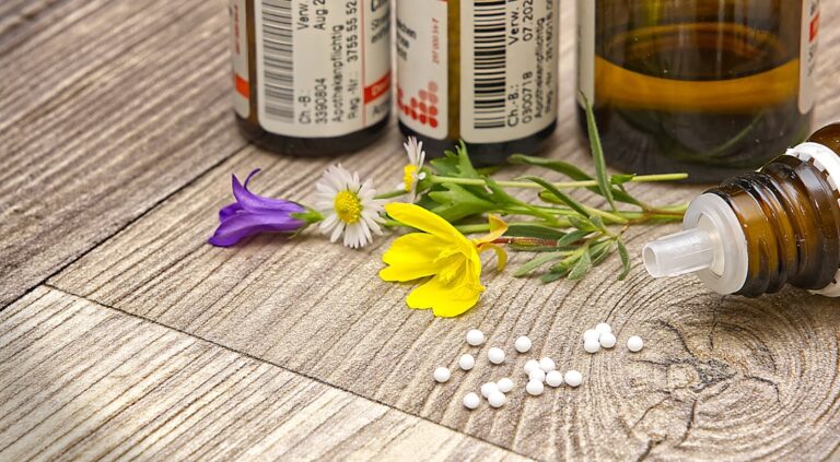 Nahaufnahme von Globuli in einem Glasbehälter zur homöopathischen Behandlung